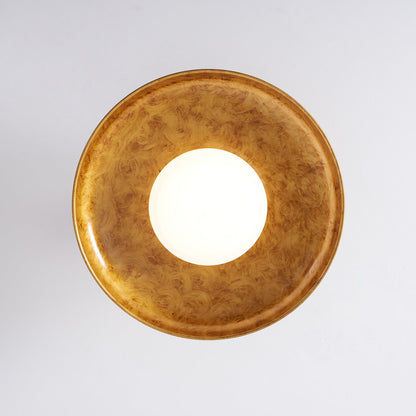 Gilded iron ceiling light seen from directly below, lit — Casa Norex