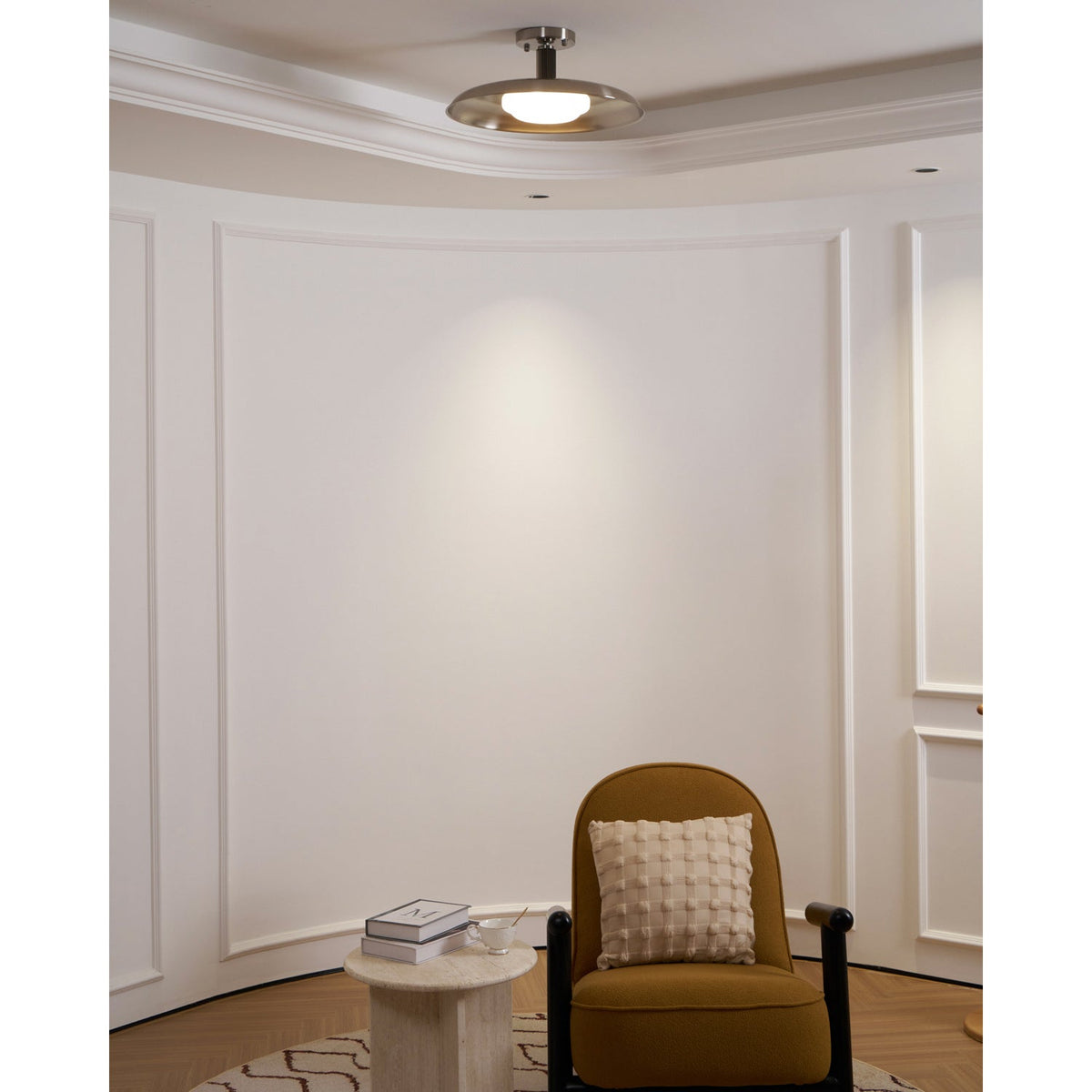 Polished nickel ceiling light in a panelled room with an armchair — Casa Norex