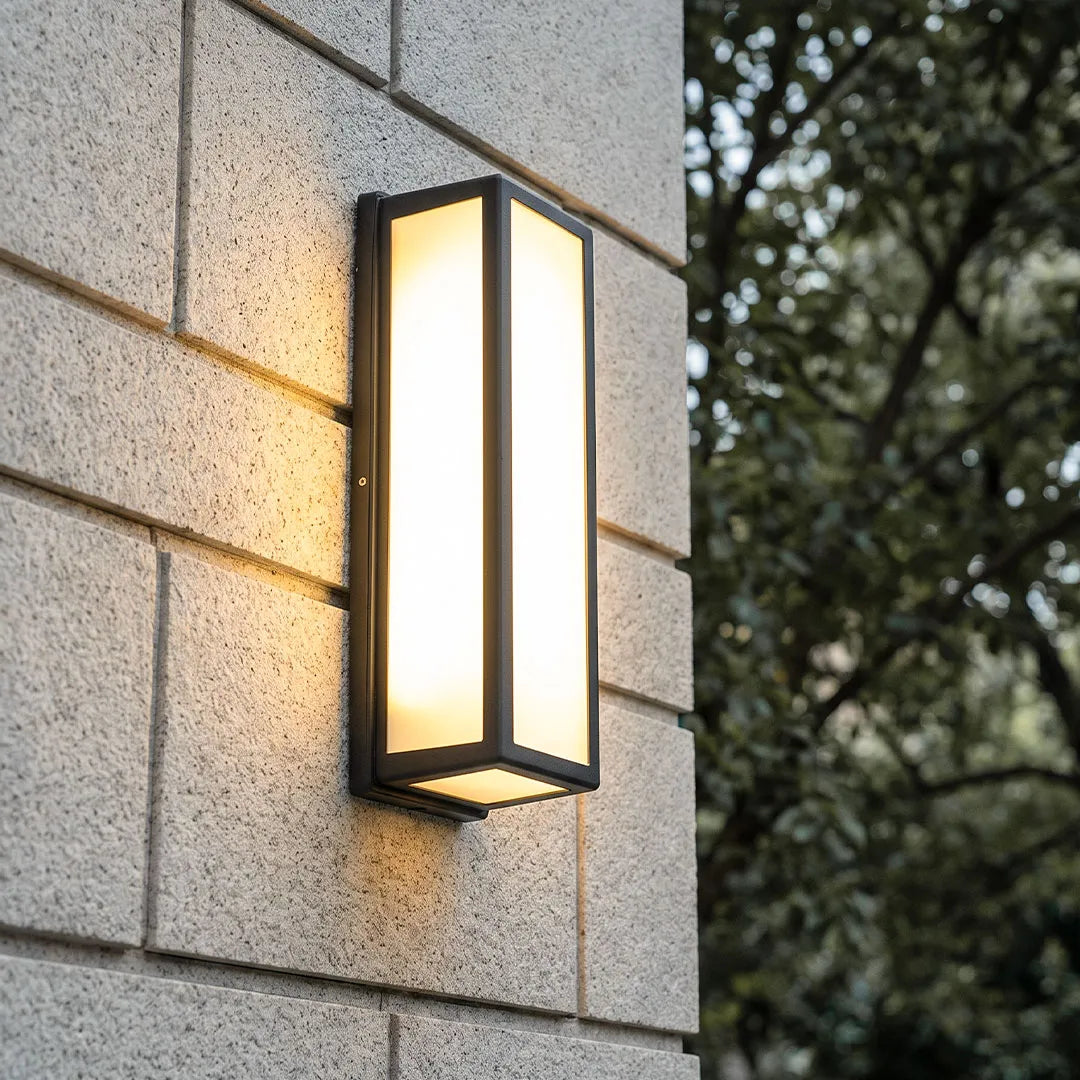 Ashby black rectangular light on a stone wall | Casa Norex