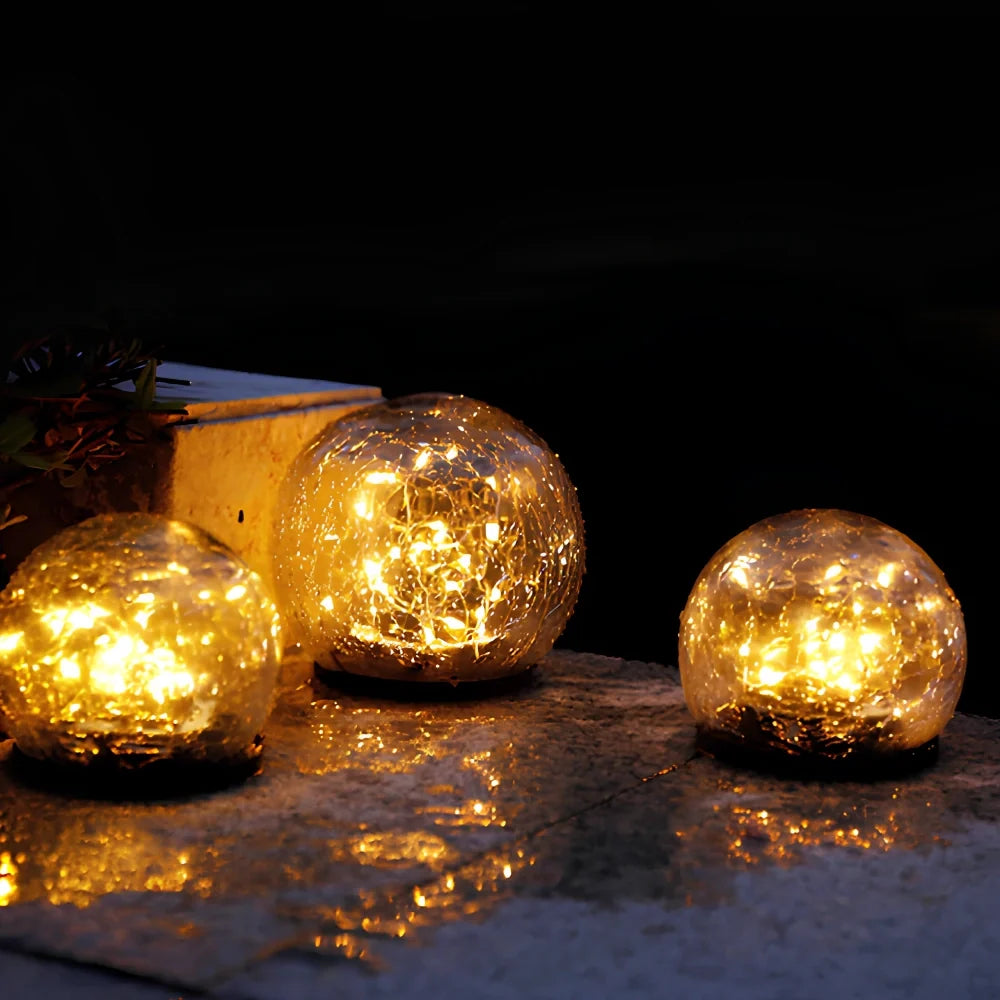 Solar glass globes reflected in a wet surface at night — Casa Norex