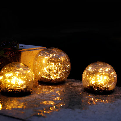 Solar glass globes reflected in a wet surface at night — Casa Norex