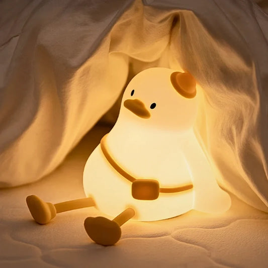 Cuddle duck night light sitting under a blanket | Casa Norex