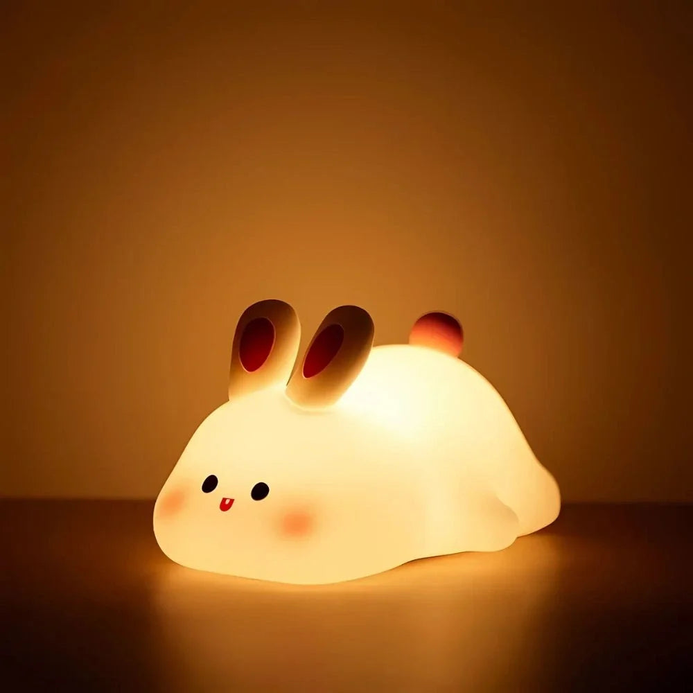 Happy Bunny silicone night light glowing on a table — Casa Norex