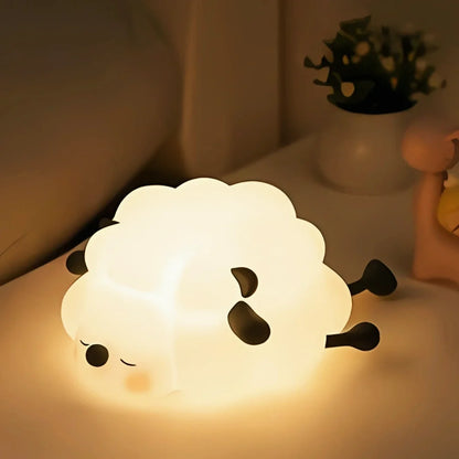 Sleepy Sheep silicone night light glowing beside a plant — Casa Norex
