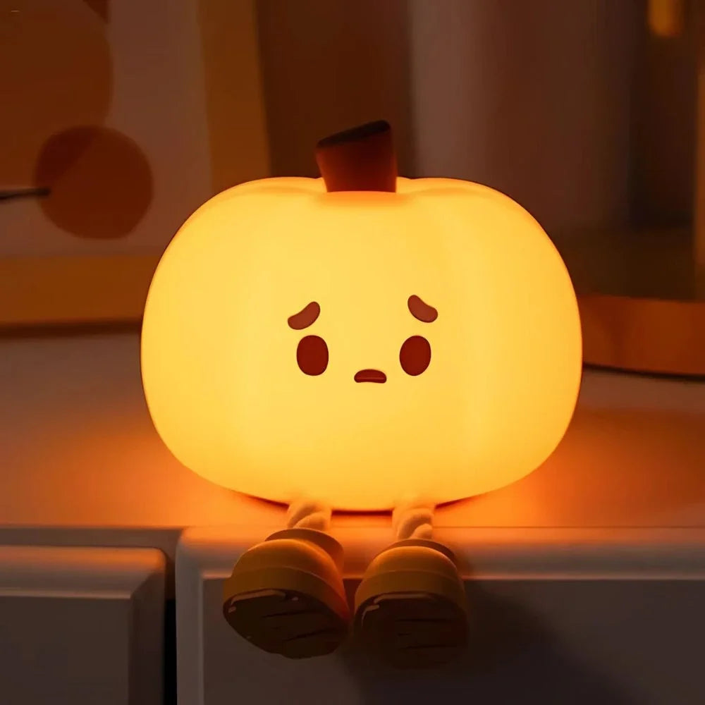 Pumpkin silicone night light with a worried face glowing orange — Casa Norex