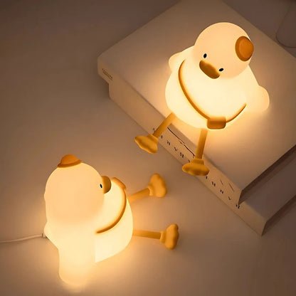 Two duck night lights glowing on a stack of books — Casa Norex
