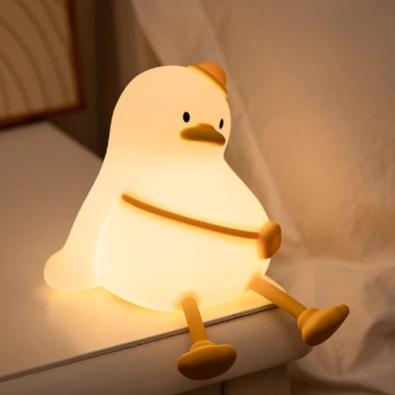 Sitting duck night light glowing on a bed — Casa Norex