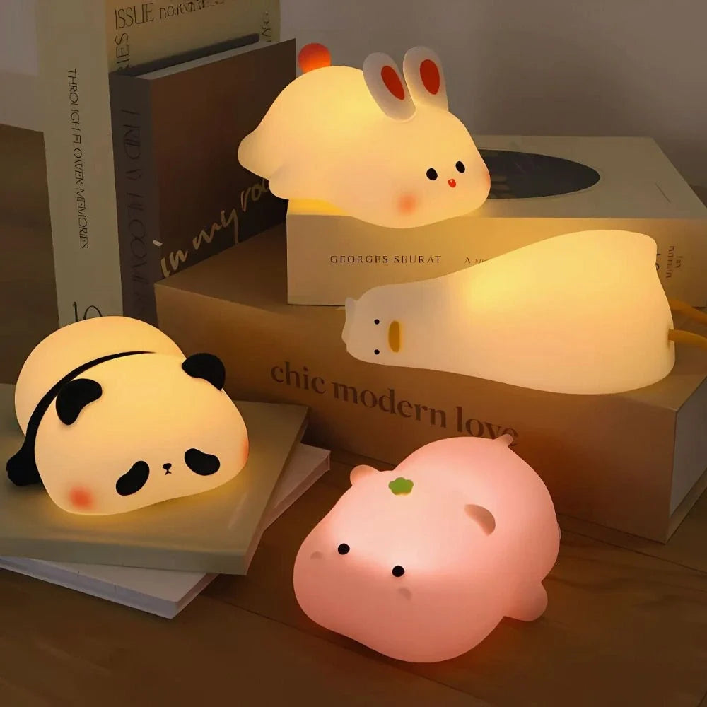 Panda, bunny and pig night lights glowing together on a desk — Casa Norex