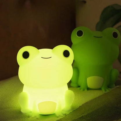 Two frog night lights glowing green — Casa Norex