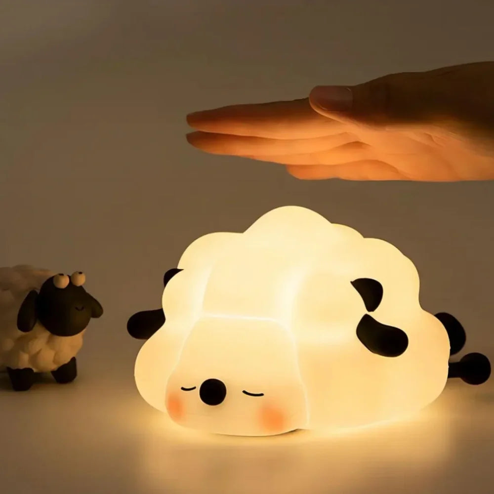 Sleepy Sheep night light glowing with a hand above it — Casa Norex