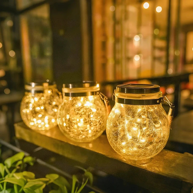 Warm glowing lanterns lined up on a wooden ledge — Casa Norex