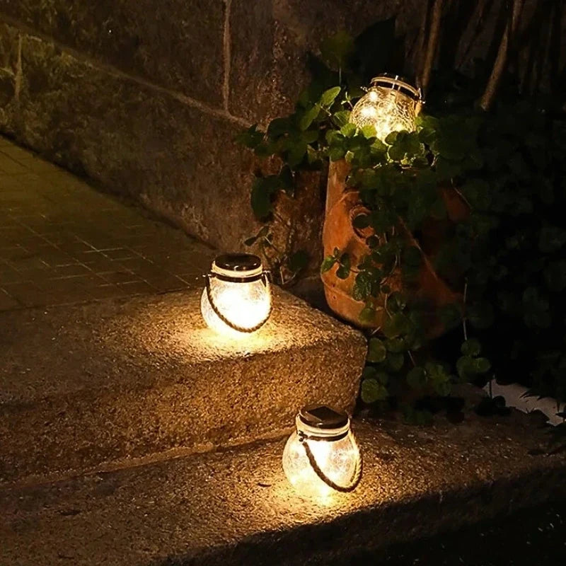 Small lanterns lighting garden steps at night — Casa Norex