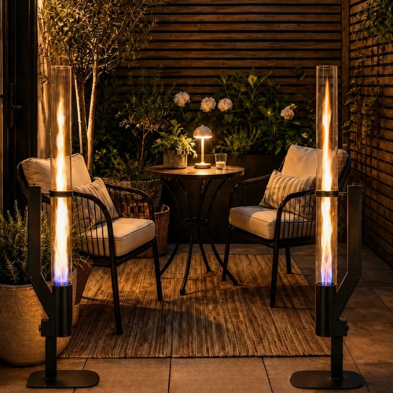 Two pellet torches either side of a bistro table on a wooden deck — Casa Norex