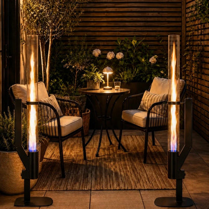 Two pellet torches either side of a bistro table on a wooden deck — Casa Norex