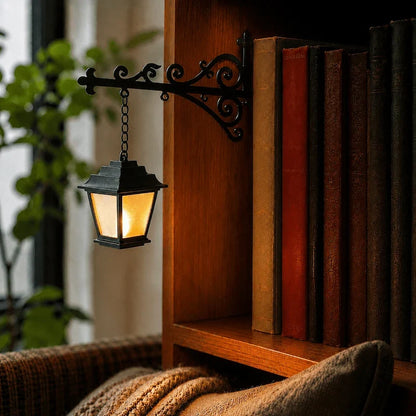 Cottage lantern pendant glowing warm white from a scrolled iron bracket by a reading chair — Casa Norex