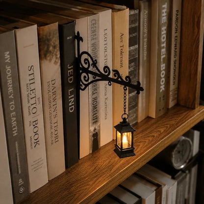 Wrought iron bracket holding a pendant light on a shelf of books — Casa Norex