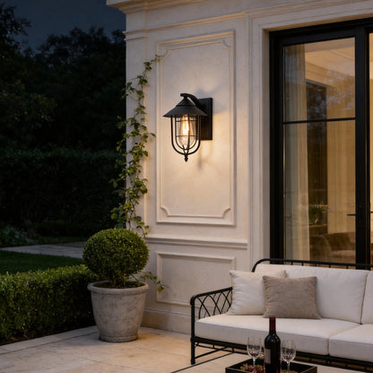 Lantern outdoor wall light in garden setting with black metal cage — Casa Norex