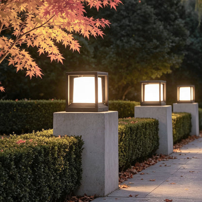 Plinth square lanterns along a hedge-bordered path — Casa Norex