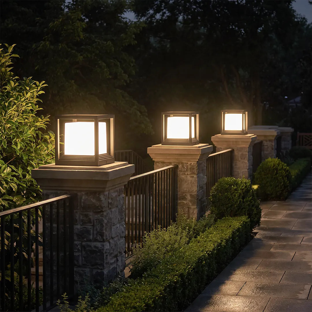 Plinth pedestal lights on stone columns along a walkway — Casa Norex