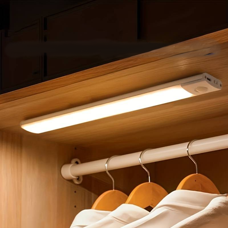 Motion sensor closet light bar under a shelf above hanging shirts | Casa Norex