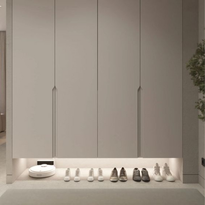 Light bar glowing above shoes in a white wardrobe — Casa Norex