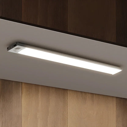 White light bar close-up under a wooden shelf — Casa Norex