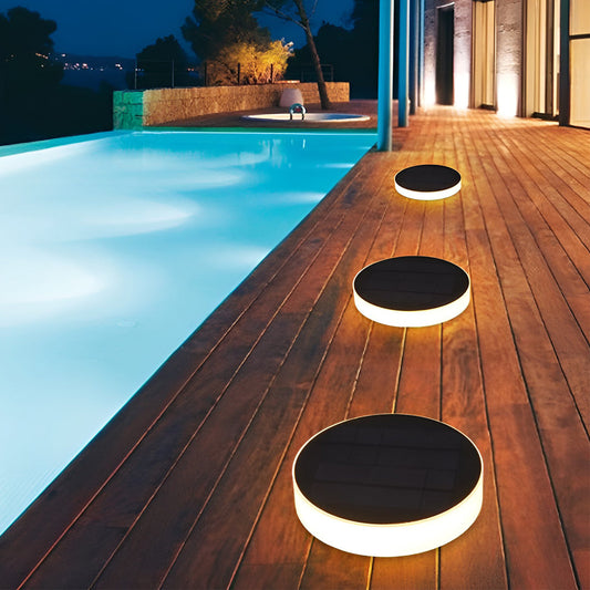 Solar pathway lights Dunmore, disc ground light on a stone walkway | Casa Norex