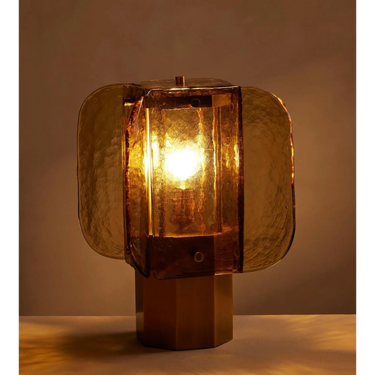 Amber glass table lamp in modern living room setting — warm ambient glow | Casa Norex