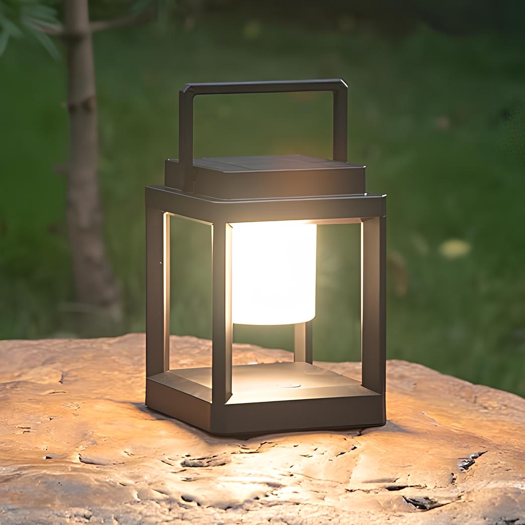 Lantern with a warm white glow resting on a flat rock in the garden — Casa Norex