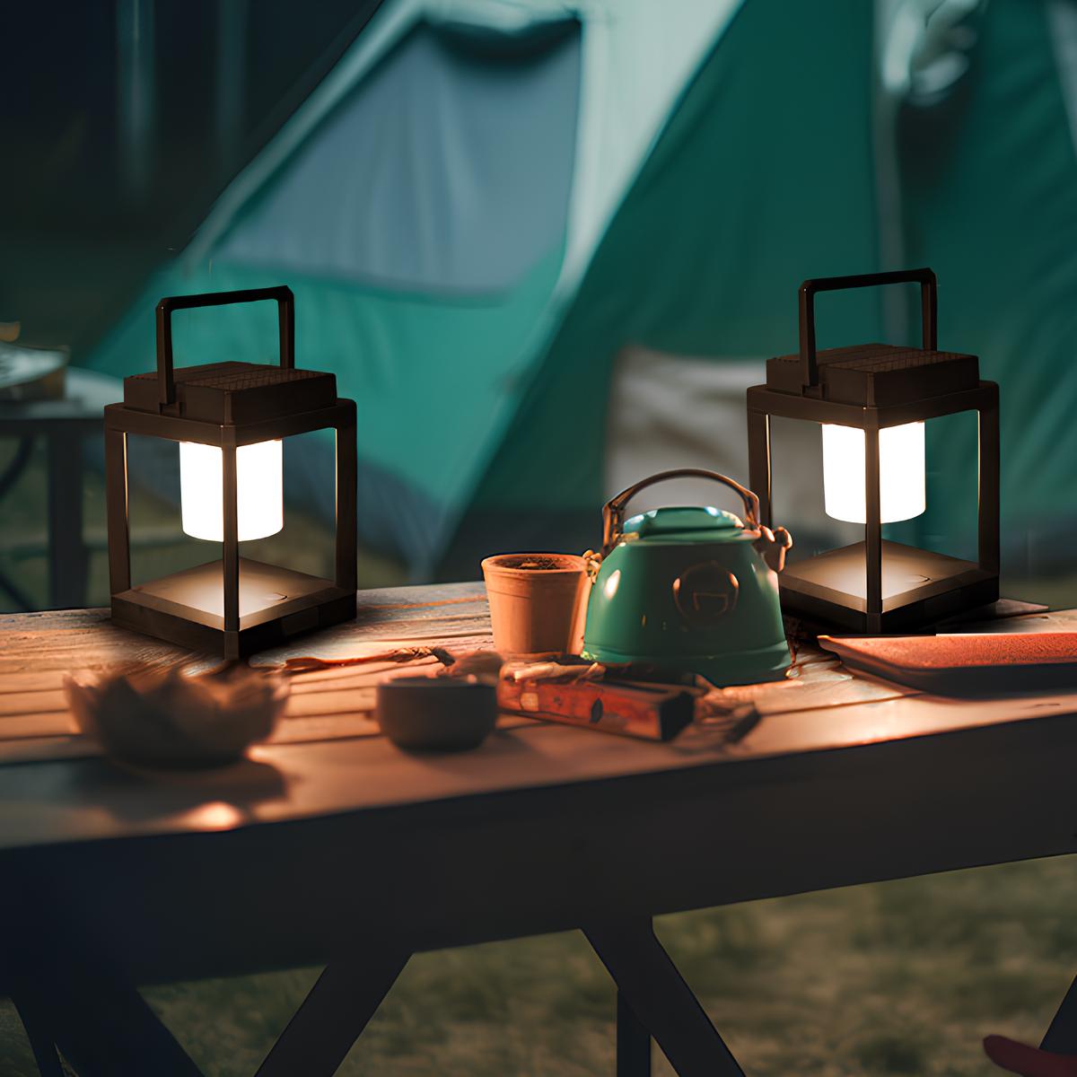 Two portable lanterns lighting a camping table beside a tent — Casa Norex