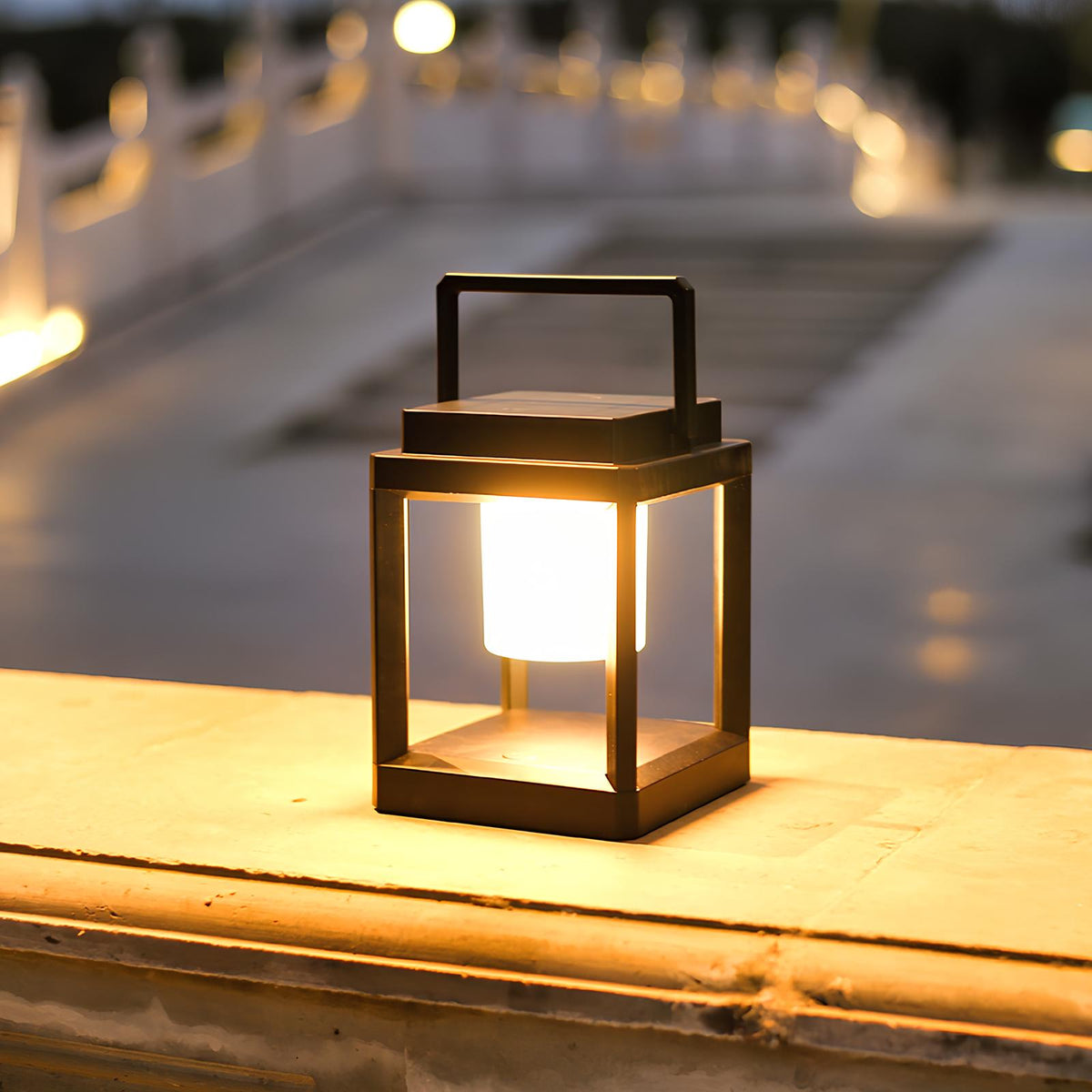 Lantern glowing on a stone ledge beside a walkway — Casa Norex