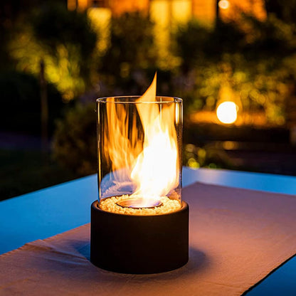Black oil lamp flame glowing on a poolside table at dusk — Casa Norex