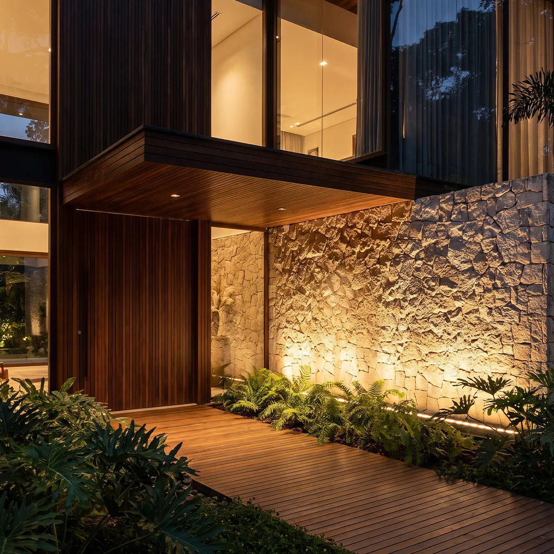 Skyline upward light on a modern stone entry wall — Casa Norex
