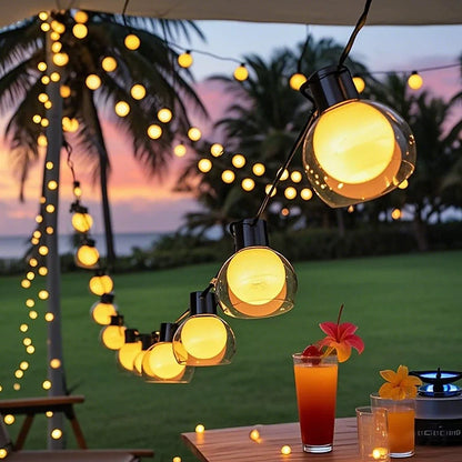 Solar globe string lights above an outdoor drinks table at sunset | Casa Norex