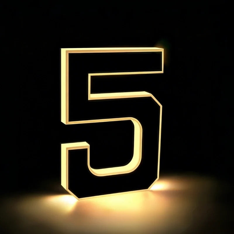 Illuminated number 5 glowing warm white against a dark background — Casa Norex