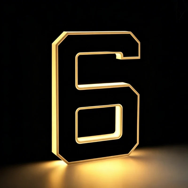 Illuminated number 6 in matte black with a warm glowing edge — Casa Norex