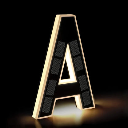 Illuminated letter A in matte black with a warm white glow — Casa Norex