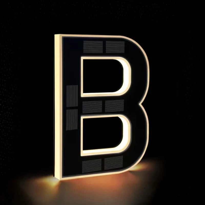Illuminated letter B outlined in warm white light — Casa Norex