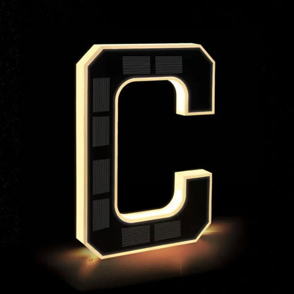 Illuminated letter C in matte black with a warm glowing edge — Casa Norex
