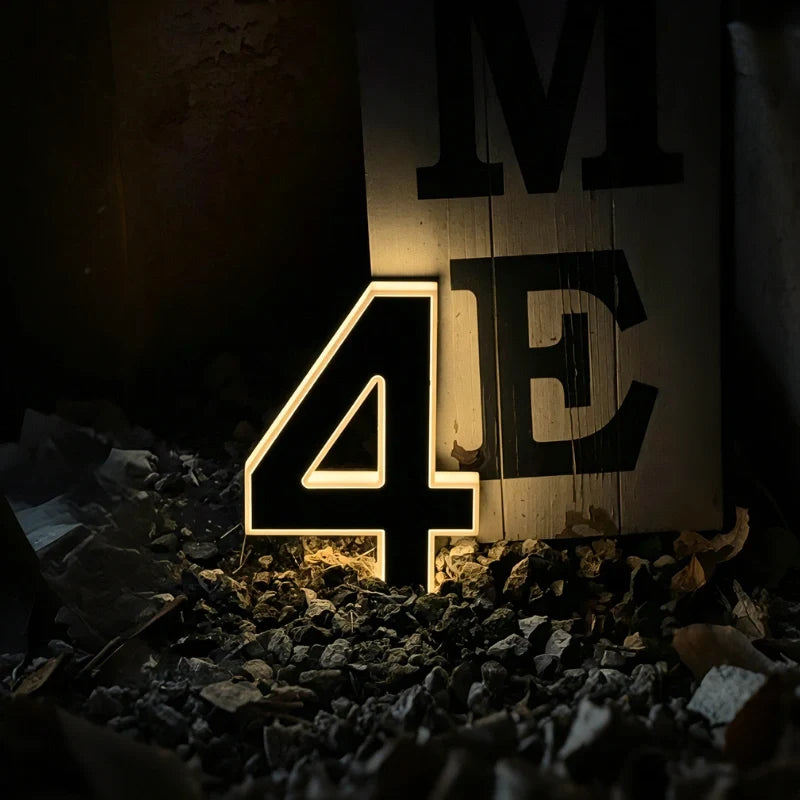 Illuminated number 4 and letters on a dark stone wall — Casa Norex