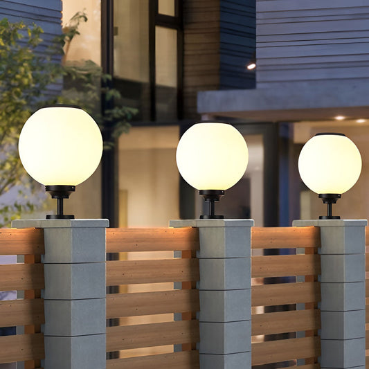 Orbit round solar outdoor pillar light on a stone pillar