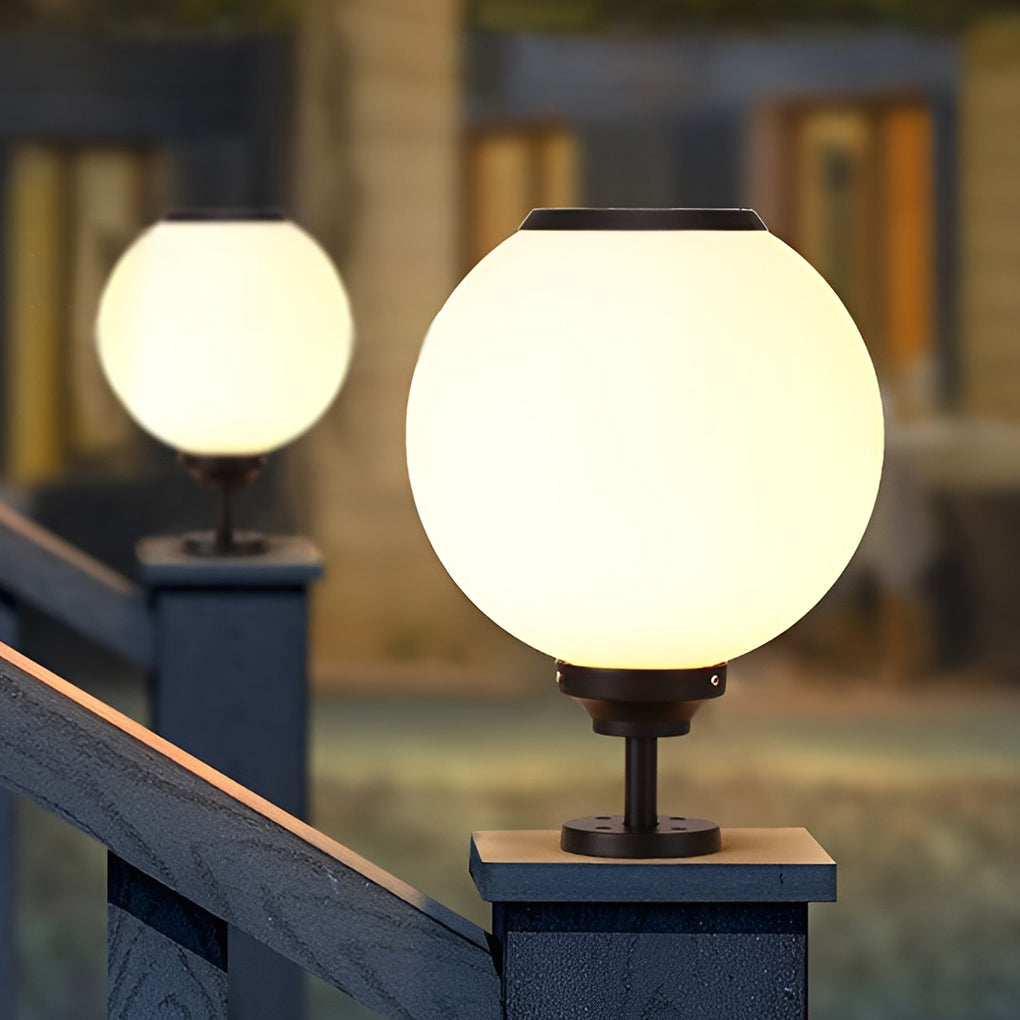 Orbit round solar outdoor pillar light on a stone pillar, front view