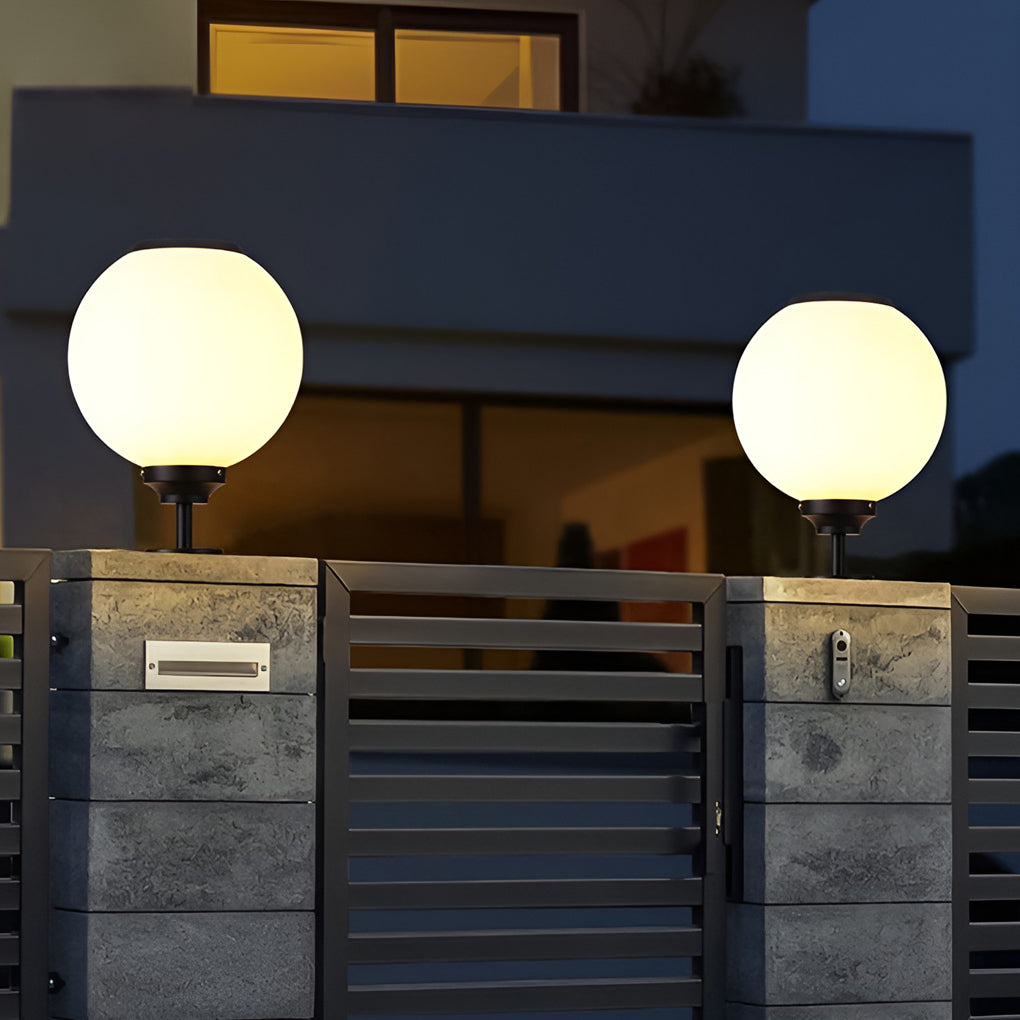 Orbit round solar outdoor pillar light warm light at a home entrance
