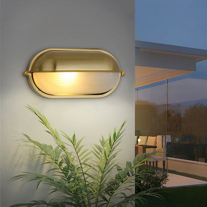 Oval bulkhead outdoor wall light on exterior wall — minimalist profile | Casa Norex