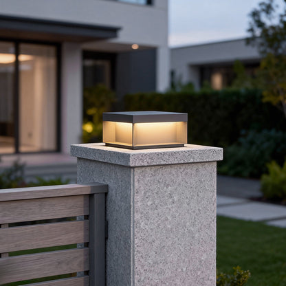 Forge post light on a stone pillar — Casa Norex