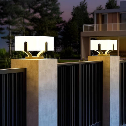 Plinth square outdoor pillar light on a stone base among plants