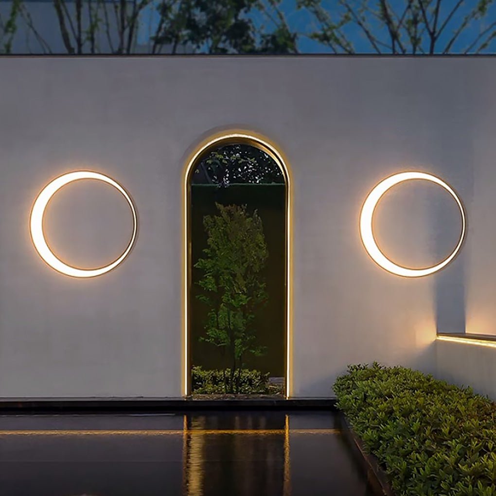 Round outdoor wall light at arched doorway on exterior wall — Casa Norex