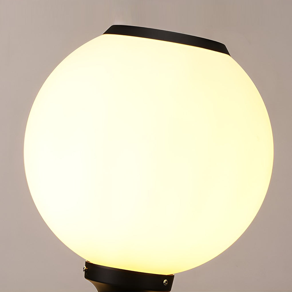 Orbit round solar outdoor pillar light lighting a garden pathway