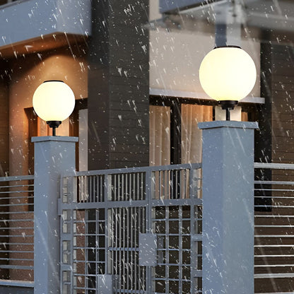 Orbit round solar outdoor pillar light bright light in a garden at twilight