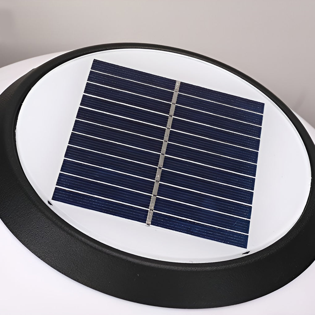Orbit round solar outdoor pillar light warm light at a garden entrance